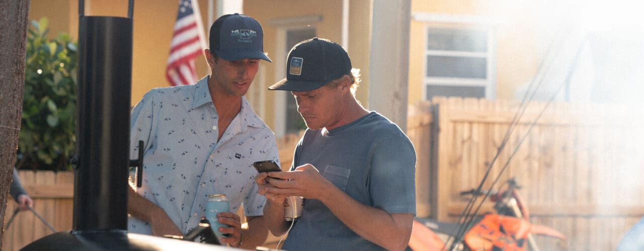 2 men looking at phone