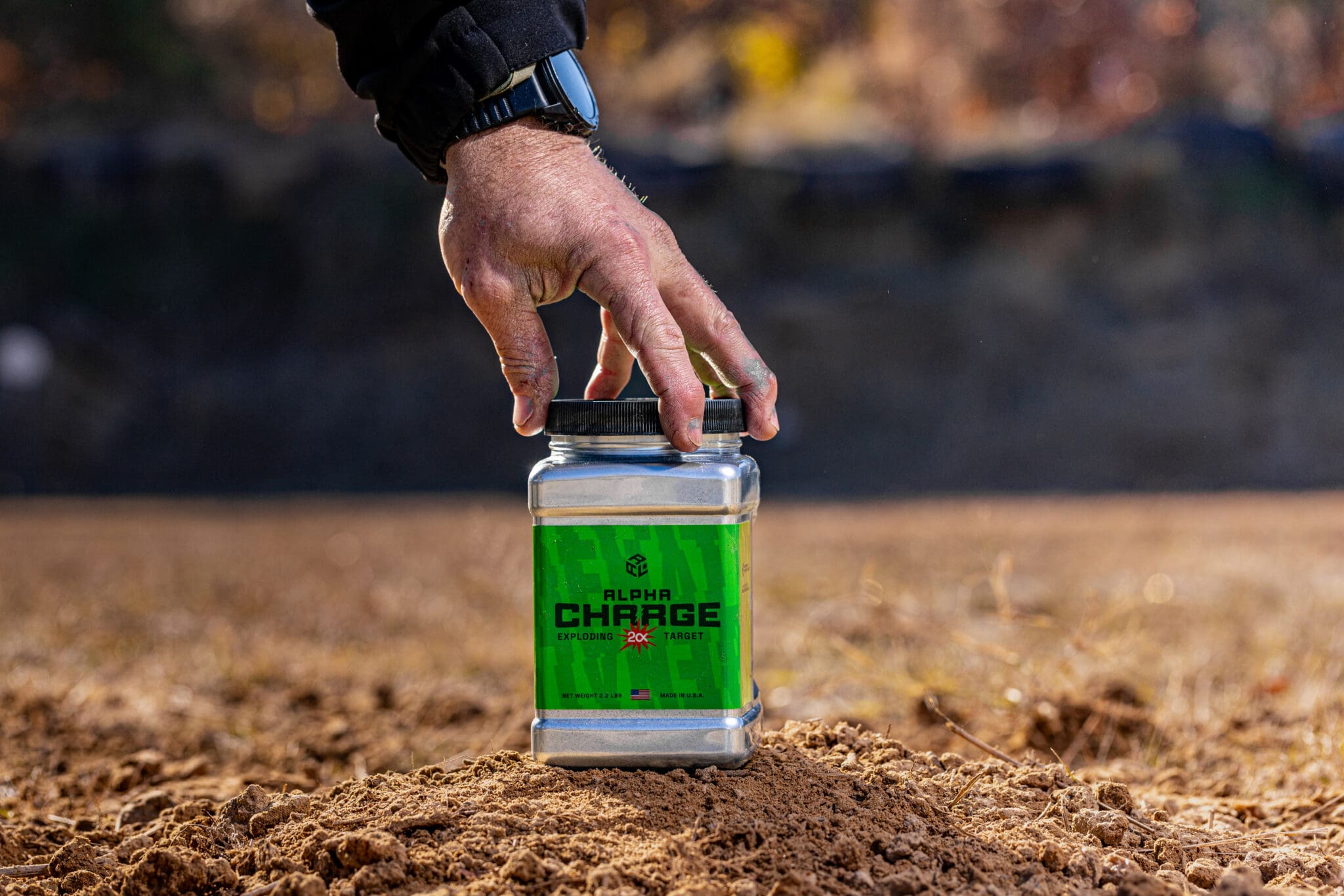 man's hand on top of the ammo package